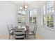 Cozy breakfast nook with a round table and gray chairs, perfect for morning meals at 233 Monterey St, Kissimmee, FL 34759