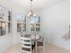 Bright breakfast nook with a round table and gray chairs near the kitchen at 233 Monterey St, Kissimmee, FL 34759
