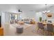 Open concept dining area with wood table, gray chairs, and view of the living room at 233 Monterey St, Kissimmee, FL 34759