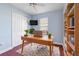 Bright home office features built-in shelving and wood desk at 233 Monterey St, Kissimmee, FL 34759