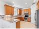 Modern kitchen with wood cabinets, granite countertops, and stainless steel appliances at 233 Monterey St, Kissimmee, FL 34759