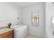 Laundry room with washer, dryer, and utility sink at 233 Monterey St, Kissimmee, FL 34759