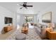 Bright living room features comfy seating, large TV, and access to a relaxing screened patio at 233 Monterey St, Kissimmee, FL 34759