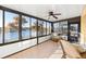 Bright sunroom with lake view and wicker chairs at 233 Monterey St, Kissimmee, FL 34759