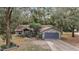 House exterior showcasing a brick facade and a gray garage door at 25900 Oakridge Ave, Sorrento, FL 32776