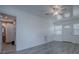 Spacious bedroom with gray vinyl plank flooring and access to the bathroom at 2729 Westland Rd, Mount Dora, FL 32757