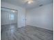 Well-lit bedroom featuring mirrored closet and wood-look floors at 2729 Westland Rd, Mount Dora, FL 32757