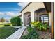 Welcoming front entry with a screened porch and nicely landscaped walkway at 27507 Pine Straw Rd, Leesburg, FL 34748