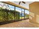 Bright screened porch with ceiling fan, view of backyard at 27507 Pine Straw Rd, Leesburg, FL 34748