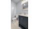 Modern bathroom with dark vanity, hex tile floor and updated fixtures at 2937 Eagles Nest Rd, Fruitland Park, FL 34731