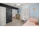 Bedroom with twin bed, chalkboard wall, and built-in shelves at 2937 Eagles Nest Rd, Fruitland Park, FL 34731