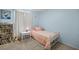 Cozy bedroom with twin bed, bookcase, and window at 2937 Eagles Nest Rd, Fruitland Park, FL 34731
