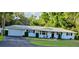 Charming single-story home with a manicured lawn, black shutters, and a two-car attached garage at 2937 Eagles Nest Rd, Fruitland Park, FL 34731