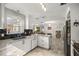 Bright kitchen featuring white cabinets, modern countertops, and stainless steel appliances at 2937 Eagles Nest Rd, Fruitland Park, FL 34731
