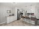 Bright, open kitchen boasting white cabinets, a breakfast bar, and stylish lighting fixtures at 2937 Eagles Nest Rd, Fruitland Park, FL 34731