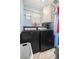 Functional laundry room with a modern washer and dryer, and ample storage space at 2937 Eagles Nest Rd, Fruitland Park, FL 34731