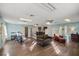 Open-concept living room featuring hard surface flooring and a kitchen in the background at 2937 Eagles Nest Rd, Fruitland Park, FL 34731