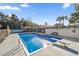 Inviting rectangular pool with diving board, surrounded by a fenced yard at 2937 Eagles Nest Rd, Fruitland Park, FL 34731
