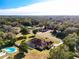 Aerial view of house, pool, and surrounding neighborhood at 305 W Lady Lake Blvd, Lady Lake, FL 32159