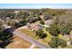 An aerial view showcasing a single-Gathering home with a pool in a tree-lined neighborhood at 305 W Lady Lake Blvd, Lady Lake, FL 32159