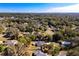 Aerial image showing a house with a pool in a quiet residential neighborhood at 305 W Lady Lake Blvd, Lady Lake, FL 32159