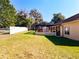 Spacious backyard with screened enclosure and fenced pool area at 305 W Lady Lake Blvd, Lady Lake, FL 32159