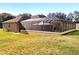 Expansive backyard with large screened pool enclosure at 305 W Lady Lake Blvd, Lady Lake, FL 32159