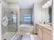 Bathroom boasts a soaking tub, walk-in shower, and double vanity at 305 W Lady Lake Blvd, Lady Lake, FL 32159