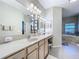 Vanity area with lighted mirror, double sinks, and ample counter space at 305 W Lady Lake Blvd, Lady Lake, FL 32159