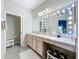 Elegant bathroom with a large vanity, lighted mirror, and separate toilet area at 305 W Lady Lake Blvd, Lady Lake, FL 32159