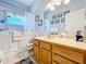 Bathroom with walk-in shower, toilet, and vanity with wood cabinets at 305 W Lady Lake Blvd, Lady Lake, FL 32159