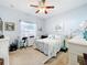 Bedroom with a queen bed, work space, and ceiling fan at 305 W Lady Lake Blvd, Lady Lake, FL 32159