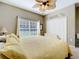 Serene bedroom with a queen bed, large window, and ceiling fan at 305 W Lady Lake Blvd, Lady Lake, FL 32159