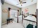 Bedroom with two twin beds, window, and ceiling fan at 305 W Lady Lake Blvd, Lady Lake, FL 32159