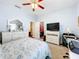 Bedroom with a queen bed, dresser, closet, and workspace at 305 W Lady Lake Blvd, Lady Lake, FL 32159