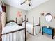 Two twin beds in a sunny bedroom with hardwood floors and decorative accents at 305 W Lady Lake Blvd, Lady Lake, FL 32159