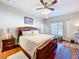 Spacious bedroom with king-size bed, wood floors, and large window at 305 W Lady Lake Blvd, Lady Lake, FL 32159