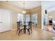 Breakfast nook with glass-top table and four chairs, near kitchen at 305 W Lady Lake Blvd, Lady Lake, FL 32159