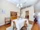 Spacious dining area with hardwood floors and antique furniture at 305 W Lady Lake Blvd, Lady Lake, FL 32159