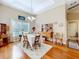 Charming dining room with hardwood floors, window light, and wooden hutch at 305 W Lady Lake Blvd, Lady Lake, FL 32159
