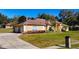 Spacious home with a circular driveway and lush lawn at 305 W Lady Lake Blvd, Lady Lake, FL 32159
