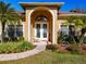 Inviting entryway with double doors and landscaping at 305 W Lady Lake Blvd, Lady Lake, FL 32159
