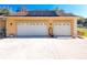 Two-car garage with solar panels on the roof at 305 W Lady Lake Blvd, Lady Lake, FL 32159
