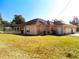 Tan house exterior with garage and large backyard at 305 W Lady Lake Blvd, Lady Lake, FL 32159