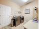 Bright laundry room with washer, dryer, and ample storage at 305 W Lady Lake Blvd, Lady Lake, FL 32159