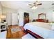 Main bedroom with king-size bed, hardwood floors, and ceiling fan at 305 W Lady Lake Blvd, Lady Lake, FL 32159