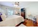 Main bedroom with king-size bed, walk-in closet, and hardwood floors at 305 W Lady Lake Blvd, Lady Lake, FL 32159