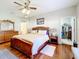 Main bedroom with a king-size bed, walk-in closet and hardwood floors at 305 W Lady Lake Blvd, Lady Lake, FL 32159