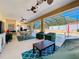 Covered patio with pool, table and chairs, and ceiling fans at 305 W Lady Lake Blvd, Lady Lake, FL 32159