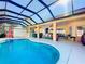 Relaxing pool area with covered patio, and outdoor kitchen at 305 W Lady Lake Blvd, Lady Lake, FL 32159